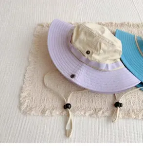 Close-up detail of outdoor sun hat with adjustable chin strap and contrast color brim, lightweight.