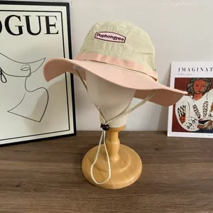 Outdoor contrast color sun hat with wide brim, adjustable chin strap, lightweight style.