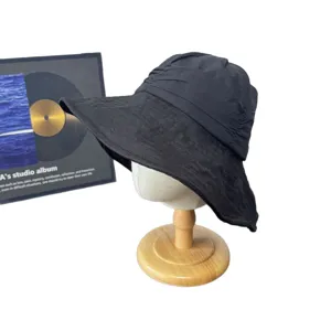 Japanese style black linen bucket hat with wide brim, simple sun protection hat for women.