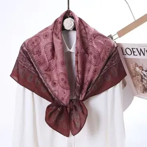 Detailed view of the elegant velvet square scarf showcasing double-sided paisley print texture.