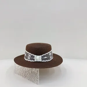 French style brown straw hat with white lace ribbon, perfect for summer beach vacation.