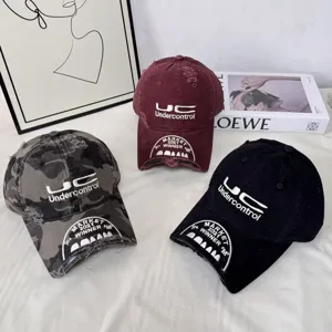 Distressed streetwear baseball cap featuring detailed embroidery and unique broken brim design.