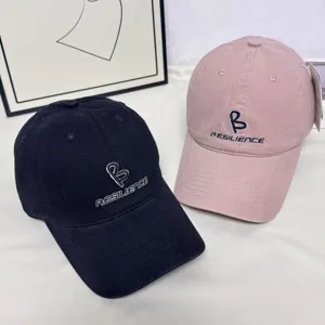 Detail view of stylish embroidered baseball cap with wide brim, featuring chic embroidery.