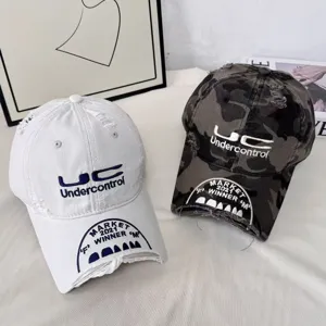 Distressed baseball cap with detailed embroidery, vintage retro style for street fashion.