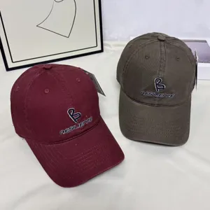 Detail view of Korean style embroidered letter baseball cap with wide brim in dual colors.
