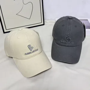 Detailed view of Korean style embroidered letter baseball cap with wide brim design.