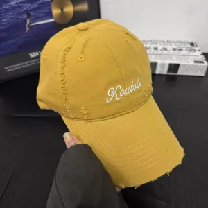 Distressed yellow baseball cap for women and men, stylish cotton soft top hat with wide brim.