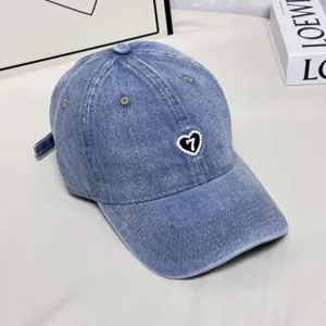 Vintage washed denim baseball cap with pearl heart embroidery and number 7 for outdoor wear.