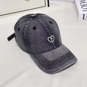 Retro washed denim baseball cap with pearl heart embroidery, casual sun hat for unisex wear.