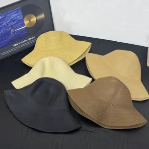 Detailed view of fashionable straw bucket hats in multiple colors for women summer vacation.