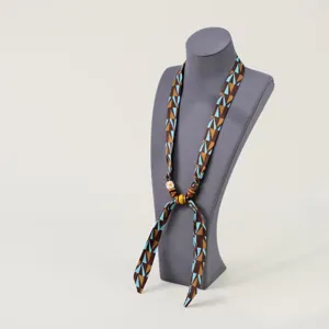 Fabric ribbon necklace with geometric pattern and wooden beads for women daily wear detail.