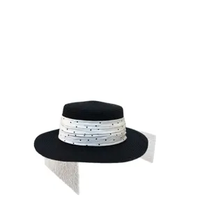 Black straw boater hat for women with chic white polka dot ribbon band for summer sun.