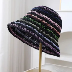 Nahaufnahme des handgefertigten Strohhuts mit bunten Pastellstreifen und feiner Strickstruktur.