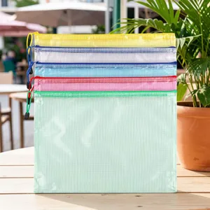 Close-up detail of colored mesh zipper file bags set on wooden table for daily storage use