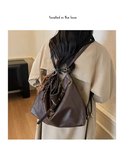 Casual brown leather multi-way backpack detail view showing soft texture and straps.