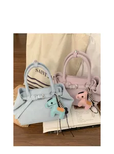 Detailed view of fashionable niche design women handbag with cute leather horse charm.