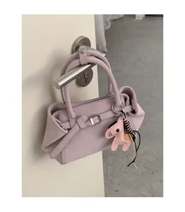 Detailed view of trendy pink women tote shoulder bag with cute horse charm and buckle.