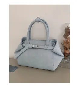 Minimalist light blue handbag detail, premium PU leather with stylish belt buckle accent.