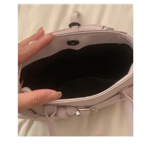 Close-up detail of the inner compartment and pink leather structure of the women bag.