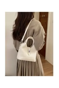 Elegant white leather bucket bag, chic handbag with lock detail for women commuting.