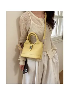 Yellow leather bucket bag for women stylish shoulder crossbody handbag detail view