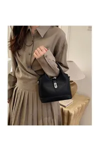 Elegant black leather bucket bag with silver hardware, classic stylish handbag for women.
