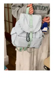 Vista dettagliata dello zaino in nylon azzurro con spallacci verde menta e stile casual.
