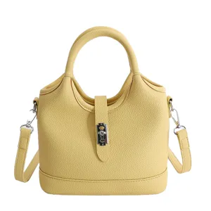 Yellow leather bucket handbag with top handles and shoulder strap for women daily commuting style