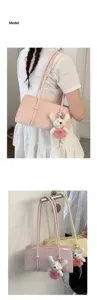 Minimalist leather underarm shoulder bag featuring a cute plush bear pendant detail.