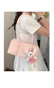 Pink leather underarm shoulder bag with cute plush rabbit charm, stylish minimalist daily handbag.