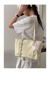 Korean style large capacity shoulder tote bag in light yellow PU leather with cute plush charm.