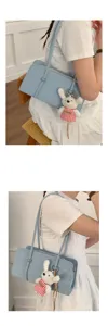 Chic light blue shoulder bag for women, stylish minimalist underarm bag with cute plush rabbit.
