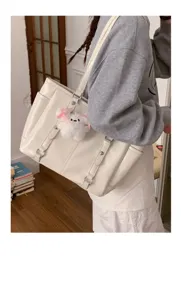 Large capacity commuter tote bag for women, stylish minimalist shoulder bag with plush charm.