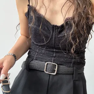 Black woven leather belt detail showing the stylish silver square buckle and textured strap.
