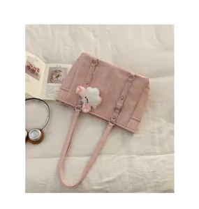 Pink PU leather shoulder tote bag detail view, casual daily commuting handbag with plush charm.