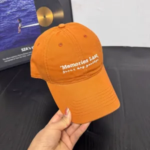 Orange cotton embroidered baseball cap with letter design, stylish casual sun hat.