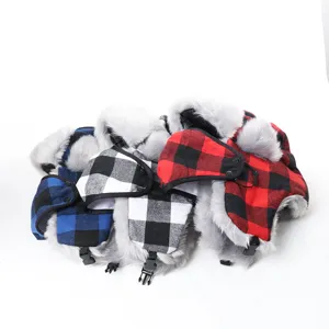 Detailed view of winter buffalo plaid trapper hats with fluffy faux fur lining and earflaps.