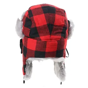 Red and black plaid trapper hat detail showing the thick plush grey faux fur lining.