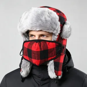 Detail shot of red and black buffalo plaid trapper hat with furry earflaps and face mask.