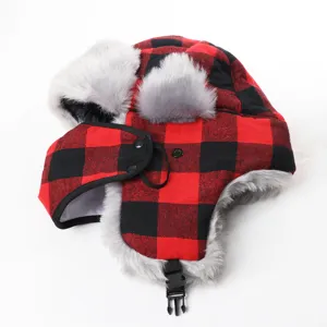 Detailed close-up view of red black plaid trapper hat with soft plush ear flaps and face mask.
