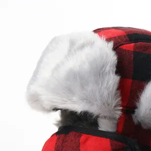 Red black plaid trapper hat with fluffy faux fur ear flaps for winter outdoor skiing cold.