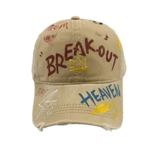 Retro distressed washed canvas baseball cap featuring trendy street graffiti art and letters.