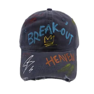 Distressed washed cotton baseball cap with colorful graffiti print and streetwear style.