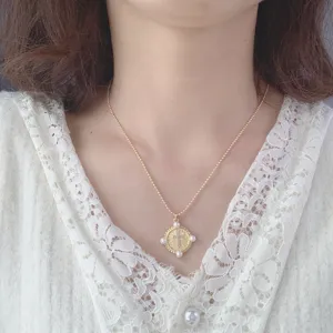 Gold bead chain necklace featuring a rhinestone cross coin pendant for women jewelry piece.