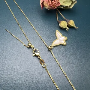 Detailed shot of a stylish natural shell butterfly necklace with a delicate gold chain.