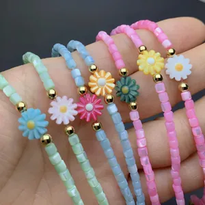 Handmade colorful beaded daisy flower bracelets detail shot, stylish and fresh aesthetic jewelry.