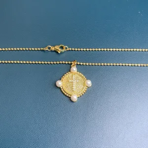Gold beaded chain necklace with rhinestone cross pendant and four pearl accents for women.