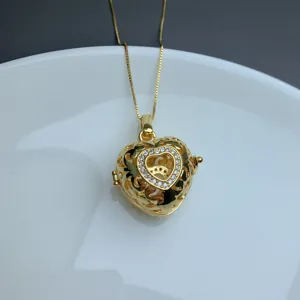 Close-up view of a chic gold-plated heart pendant necklace featuring delicate sparkling stones.