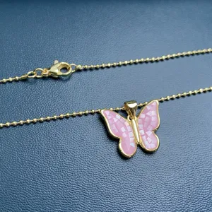 Delicate gold ball chain necklace featuring a pink shell mosaic butterfly pendant detail.