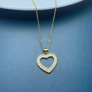 Gold heart pendant necklace detail showing sparkling cubic zirconia stones clearly and elegantly.